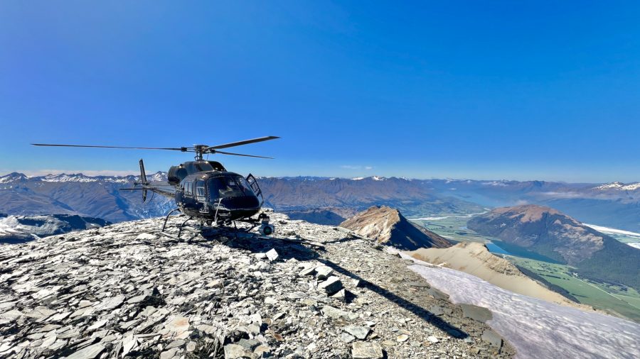 Aerial cinematography in action: filming dramatic alpine landscapes only accessible by helicopter.